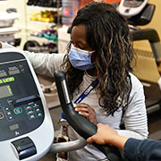 health professional setting up an exercise machine